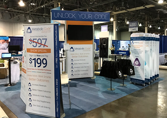 Metabolic Code trade show booth with pricing and program signage